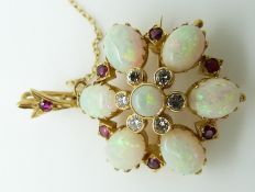 An 18ct gold pendant/ brooch set with seven opal cabochons, rubies and diamonds