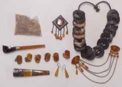 Collection of amber items including brooches, pipe, cufflinks, beads, etc
