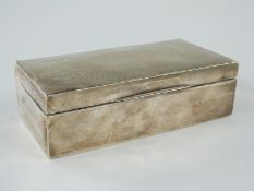 A hallmarked silver cigarette box with engine turned lid, marks rubbed, length 16.5cm