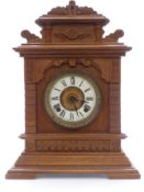 Ansonia oak table/mantel clock in carved case, Roman dial, Beetle and Poker hands, striking on a