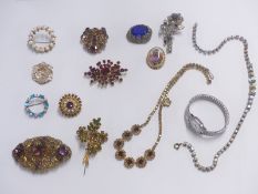 A collection of costume jewellery brooches, two crystal necklaces and a watch