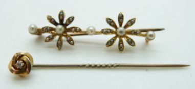 Edwardian brooch set with seed pearls in a floral design and a 15ct gold stick pin set with a