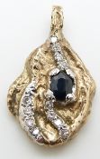 A yellow metal bi-coloured nugget style pendant set with an oval cut sapphire and diamonds, 13.1g