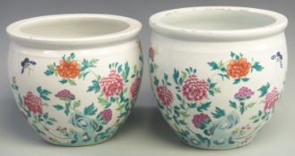 A near exact pair of 19thC Chinese jardinieres decorated with flowers and insects, height 24cm,