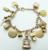 A 9ct gold charm bracelet with 11 charms including seal, kangaroo, cherub, shell, St Christopher