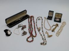 A collection of costume jewellery to include silver and marcasite watch, silver pendant, pearl