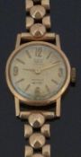 Britix 18ct gold ladies wristwatch with gold hands and hour markers and champagne dial, on 9ct