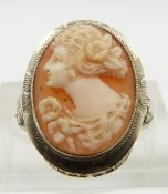 A 14k white gold ring set with a shell cameo and with pierced shoulders, size L