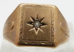 A 9ct gold ring set with a diamond in a star setting, 5.7g, size S