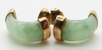 A pair of gold earrings set with jadeite