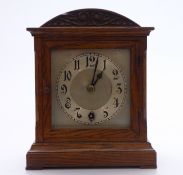 Oak cased mantel clock c1930, the silvered Arabic dial with spade hands, 25cm tall.