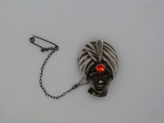A hallmarked silver brooch in the form of a blackamoor figure, London 1947