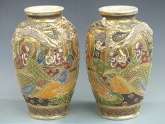 A pair of Japanese Satsuma vases decorated with figures and dragons, height 30cm