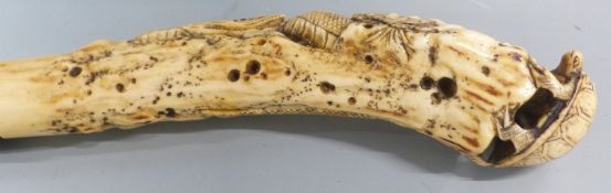 A late 19thC/20thC parasol, the handle a Meiji period carved ivory okimono in the form of a snake