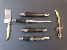 Four decorative knives including a set of two Miniature Samurai swords, largest 29cm long.