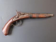 Percussion hammer action pistol with one leather and two metal bands, studded decoration and 8