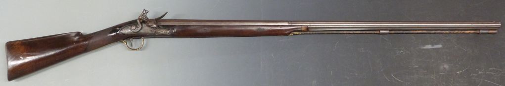 Flintlock hammer action sporting gun with chequered grip and forend, engraved lock and top plate,