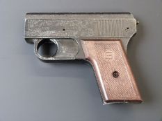 Italian starting pistol with ornate scrolling decoration and chequered grips stamped GP, 15cm long.