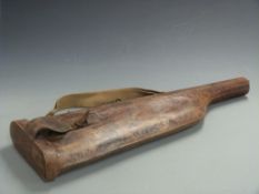 A 19thC 'leg of mutton' leather gun case with brass clasp and additional canvas shoulder strap,
