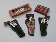 Five vintage childrens cap guns comprising The Outlaw Kid MKII 100 Shot Repeater Cap Pistol and Chad