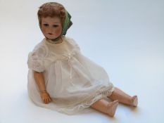 Armand Marseille bisque headed doll with open mouth, weighted brown eyes, brown hair, articulated
