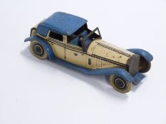 Wells & Co of London clockwork tinplate car with cream body, blue arches and roof, black decoration,