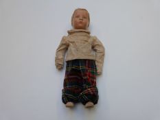 German lacquer headed boy doll with closed mouth, blue eyes, blonde hair and jointed canvas body,