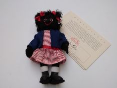 Steiff Teddy bear Golly Girl with black felt body, blue jacket and striped dress, limited UK and