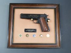 John Wayne Armed Forces Commemorative replica .45 automatic pistol with signature to one side, on