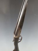 Robust 12 bore side by side shotgun with chequered grip and forend, double trigger and 30 inch