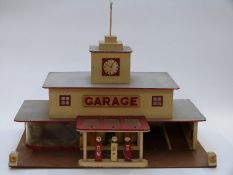 A large wooden model car garage with diecast fuel pumps, 61 x 40 x 48cm