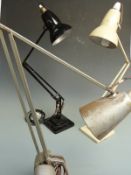 Two free standing Anglepoise lamps by Herbert Terry, Redditch, together with a clamp on example