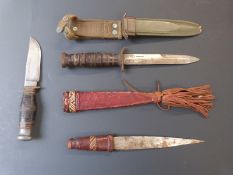 A US Marines knife in sheath, sheath knife and Eastern dagger. Longest blade 16.5cm.