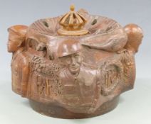 A carved Royal Air Force / Royal Flying Corps propeller boss depicting symbols for overseas