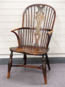 An 18th/19thC Windsor armchair with elm seat and crinoline stretcher