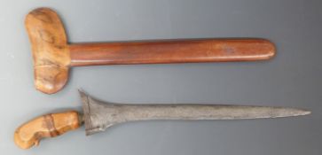 A 19thC Malaysian Kris with watermarked/etched blade, carved handle and jewelled mount, in