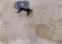 Collection of children's vintage clothing including capes, sailor collars, dresses etc