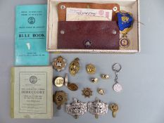 A collection of military badges to include Gloucestershire, RASC, Devonshire, USA etc together