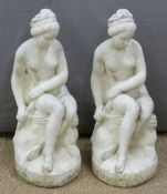 Two garden statues of semi nude seated ladies, height 60cm