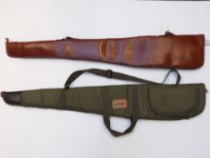 Two shotgun or rifle slips one brown leather with shoulder sling the other Jack Pyke with additional