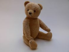 English Teddy bear, possibly Farnell or Steiff, with blonde mohair, shaved snout, glass eyes,
