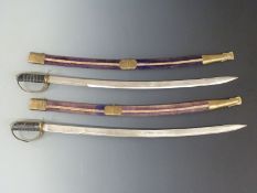 Two small swords in scabbards made in India. Blade length 77cm.