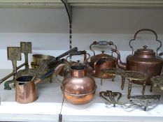 A quantity of copper and brass items to include tea pots, five dogs, trivets, oil lamp etc
