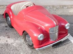 Austin Junior J-40 pedal car in red, with opening bonnet to reveal dummy engine, opening boot,