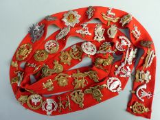 A collection of British Army cap badges including South Wales Boarders, Fife & Forfar Yeomanry,