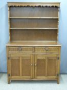 Oak dresser with carved decoration and plate rack above, W125 x D48 x H182cm