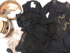 A collection of textiles to include vintage evening dresses, a silk shawl, a lace trimmed bed cover,