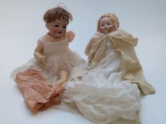 Two Armand Marseille bisque headed dolls, one with closed mouth, weighted blue eyes, soft body and