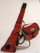 A matching suede and leather cartridge bag and gun slip, both with brass mounts and shoulder straps.