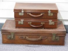 Three vintage leather suitcases, largest W67 x D37 x H17cm